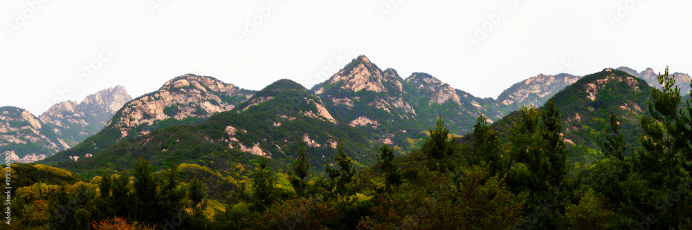 Naklejka premium Panoramic Foggy Bukhansan Mountain landscape above northern Seoul, its three granite peaks reaching 2,744 feet, overlooking the city with timeless natural beauty