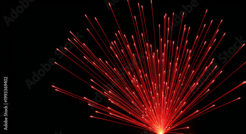 A vibrant burst of red light streaks emanate from a central point in darkness