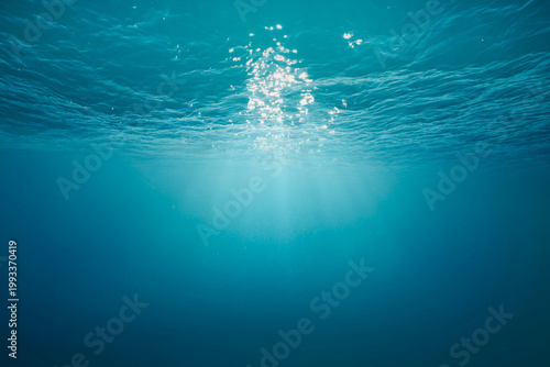 Sunlight Rays Underwater Surface, Clear Blue Ocean Background with Light Reflections