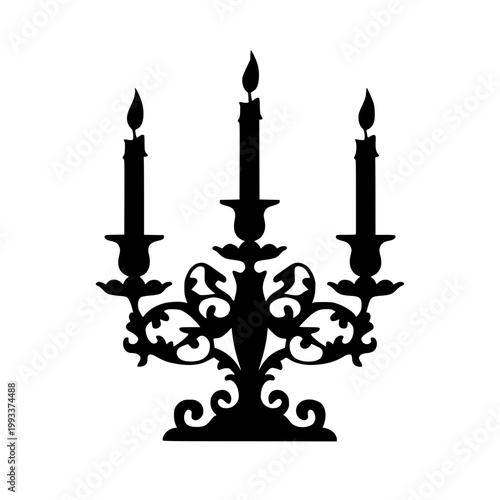 Ornate black silhouette of a three-branched candelabra holding lit candles standing on a pedestal