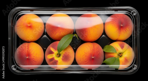 Fresh Ripe Peaches in a Transparent Plastic Container on Black Background