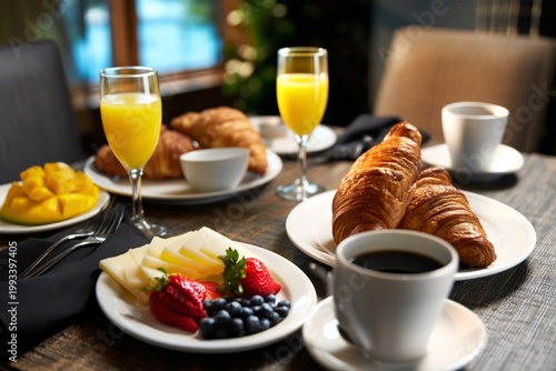 Breakfast Spread With Coffee, Croissants, Fruit, and Juice at a Dining Table