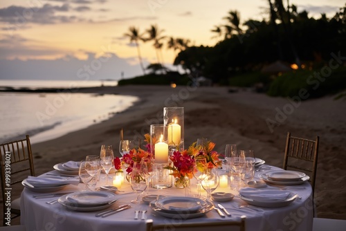 Sunset Dinner Setup on a Beach With Candles and Flowers