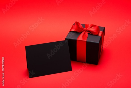 Gift Box With Red Ribbon and Card on a Red Background