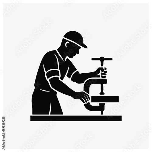 Silhouette of a machinist operating a manual lathe machine
