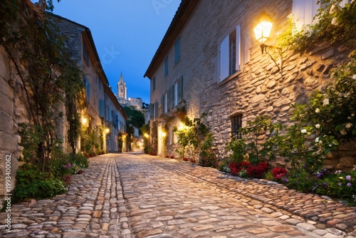 Nighttime Scene of a Cobblestone Street in a Quiet Town Under Soft Streetlights