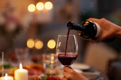Wine is Poured Into a Glass During a Dinner Gathering With Friends at Home