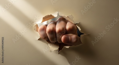 Strong Human Fist Breaking Through A Paper Sheet