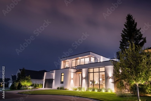 Modern House With Bright Lights at Night in a Quiet Neighborhood