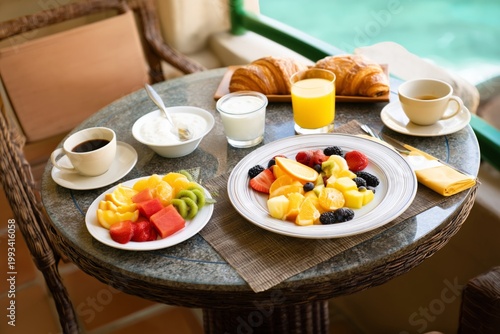 Breakfast With Fruits and Drinks on a Balcony by the Pool in the Morning Sun