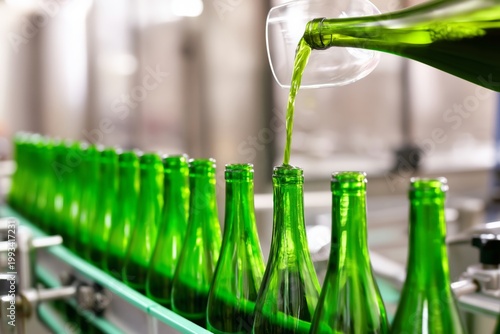 Bottles Move Along the Production Line in a Factory During the Day