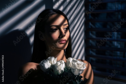 Woman Looking out Window With Flowers in Hand, Shadows Cast by Blinds at Dusk
