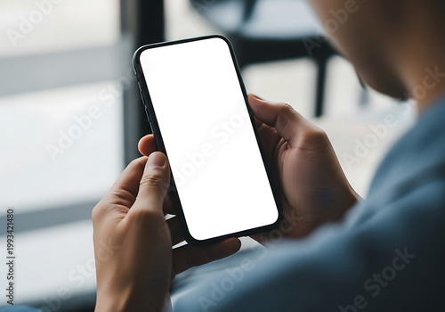 Person holding a smartphone with a blank screen