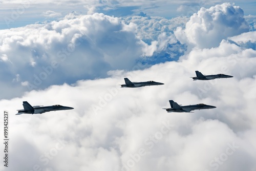 Military Jets Fly Over Clouds in Formation During Aerial Training Exercise in...