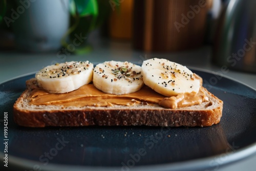 Peanut Butter Toast With Banana Slices and Seeds on a Plate in a Kitchen