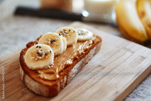 Peanut Butter Toast With Banana Slices and Seeds on a Plate in a Kitchen
