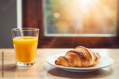 Fresh Orange Juice and Croissant on a Wooden Table Near a Sunny Window in the...