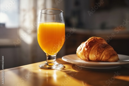 Croissant and Orange Juice on a Table in Morning Light
