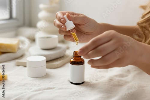 Women Adds Drop of Oil to Brown Bottle in Kitchen During Afternoon