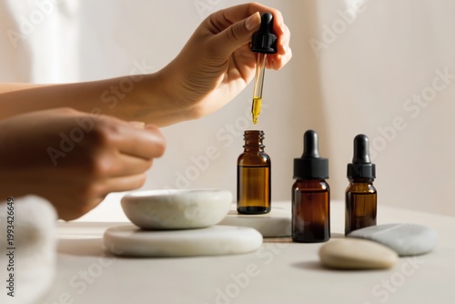 Women Adds Drop of Oil to Brown Bottle in Kitchen During Afternoon