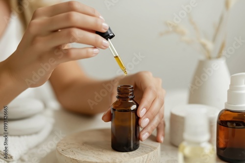 Women Adds Drop of Oil to Brown Bottle in Kitchen During Afternoon