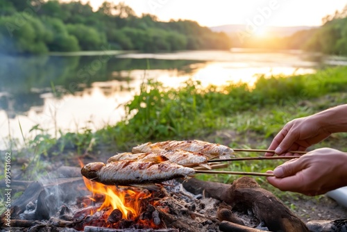 Cooking Fish Over Fire Near a River at Sunset in Nature
