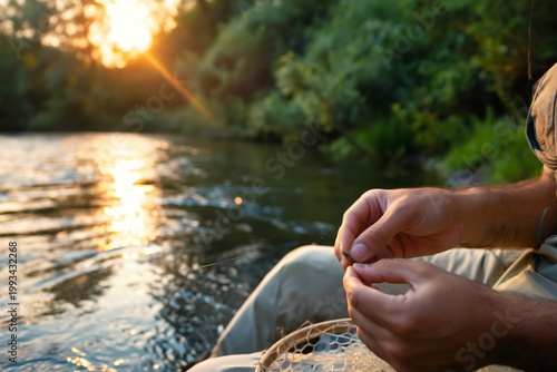 Man Prepares Fishing Lure by the River During Sunset Near Trees and Water