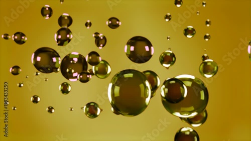 Large gold-green oil bubbles move among smaller particles in a yellow-brown liquid. The realistic animation features the spheres floating, interacting, and colliding, making it ideal for culinary vide