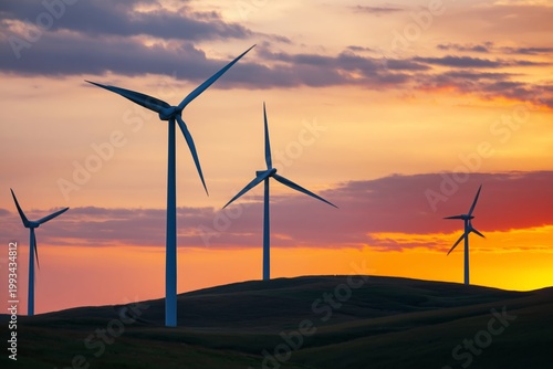 Wind Turbines Stand Against a Sunset Sky in a Rural Area With Hills and Clouds