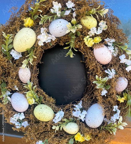 A decorative seasonal wreath on a traditional wood panelled door.