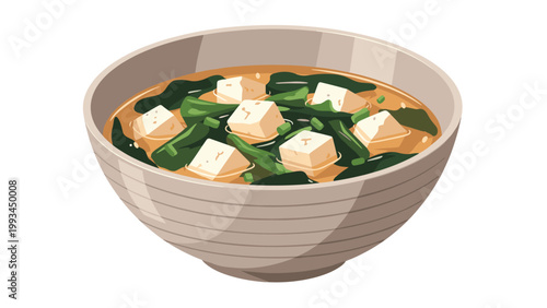 Large ceramic bowl of traditional Japanese miso soup containing pieces of white tofu and green seaweed in a savory broth.