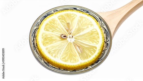 Lemon slice in glass of water on wooden spoon.