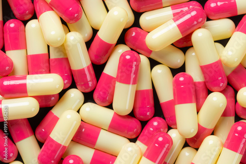 pink and yellow hard gelatin capsules for background.