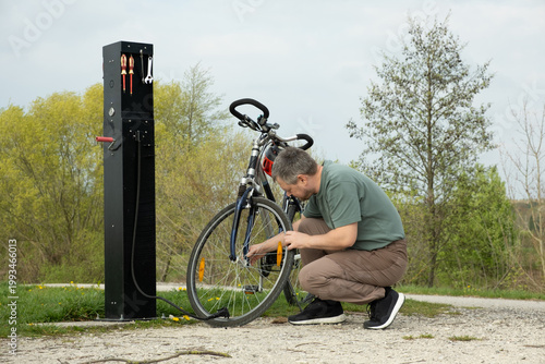 Wallpaper Mural Maintenance of a mountain bike at a public repair pillar. Torontodigital.ca