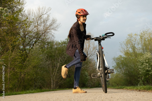 Wallpaper Mural Female cyclist stopped on a path holding her pained knee, sport injury concept Torontodigital.ca