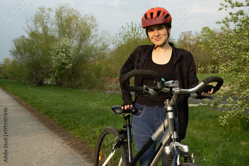 Wallpaper Mural Female cyclist standing with her bike, adjusting seat height for comfortable ride Torontodigital.ca