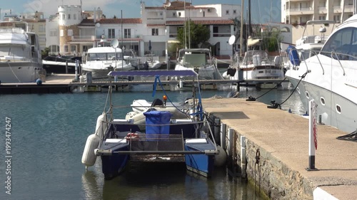 Boats and catamaran are parked at the marina by the water. Empuriabrava, Spain