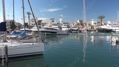 Boats and yachts are in a marina with clear water. Empuriabrava, Spain