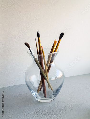 Brushes and pencils in a glass vase