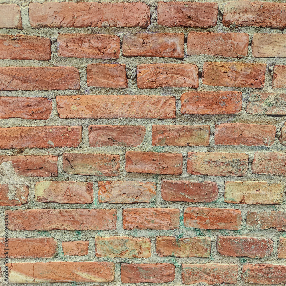 Fototapeta premium Weathered brick wall texture background with rustic red and orange tones