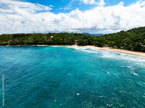 Aerial flying drone view seashore waves water surface texture in sunny tropical ocean at Phuket island Thailand