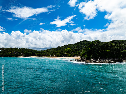 Aerial flying drone view seashore waves water surface texture in sunny tropical ocean at Phuket island Thailand