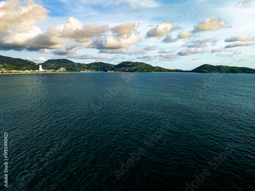 Aerial flying drone view seashore waves water surface texture in sunny tropical ocean at Phuket island Thailand