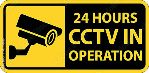 Yellow warning sign indicating twenty four hour CCTV surveillance operation