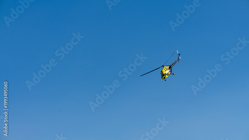 yellow helicopter in flight