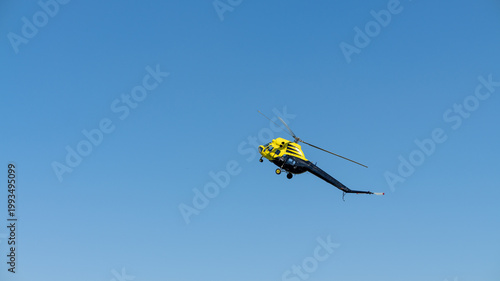 yellow helicopter in flight