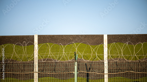 Barbed wire fence against clear sky, security and restriction concept