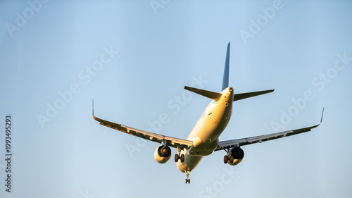 Passenger airplane approaching for landing against clear sky, front view