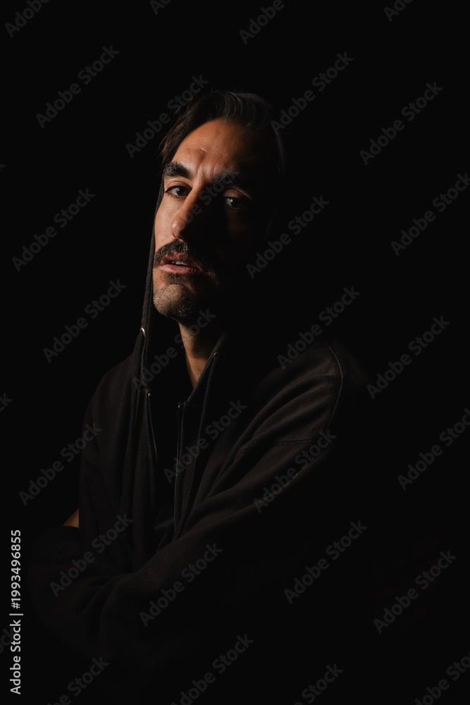 Fototapeta premium Mysterious figure in shadows reveals deep emotions after dark night