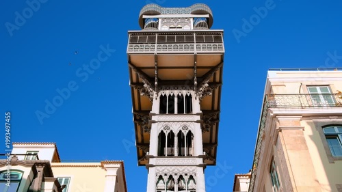 Upshot of Santa Justa elevator under blue sky, Lisbon, Portugal on